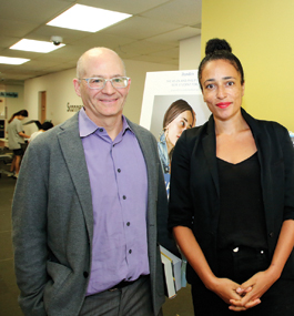 Plotz and Smith pose standing in the Brandeis Library.